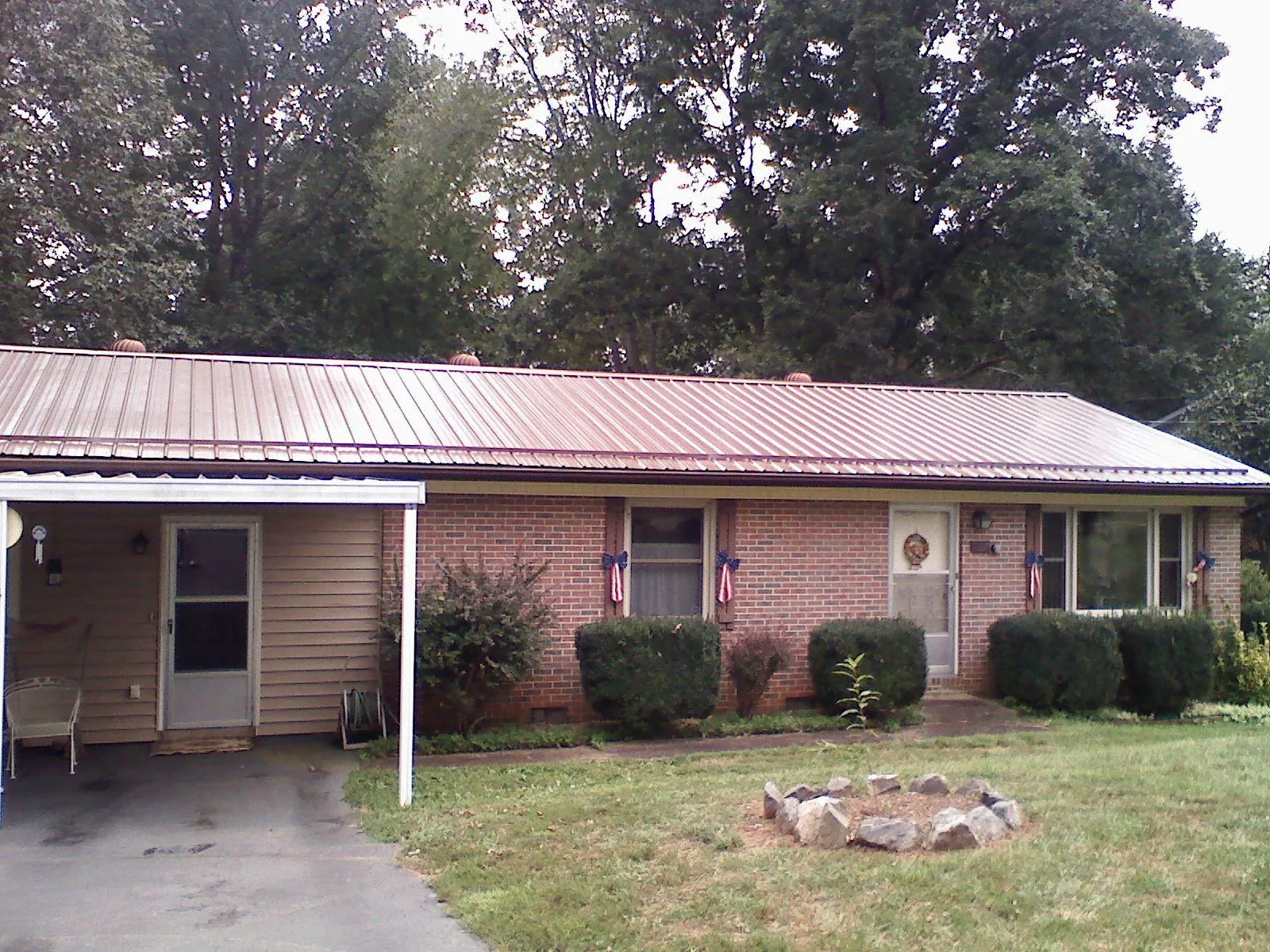 Bronze metal roof and carport on a brick ranch home — Roof Repair work by our crew in Shafer