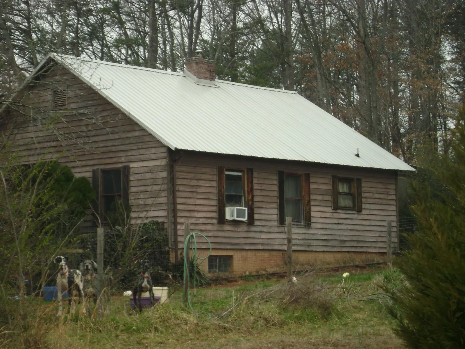 White metal roof on an old wood sided farmhouse, from a Metal Roof Installation job in Shafer
